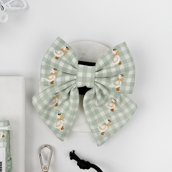 Green and white check print dog sailor bow tie with embroidered geese design.