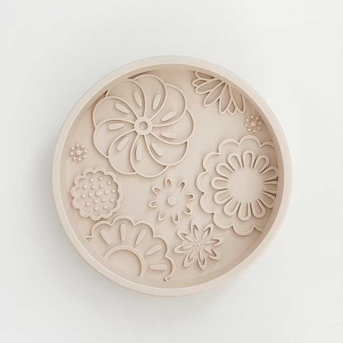 Baby pink silicone dog bowl with flower pattern, featuring a textured slow feeder design by Cocopup London.