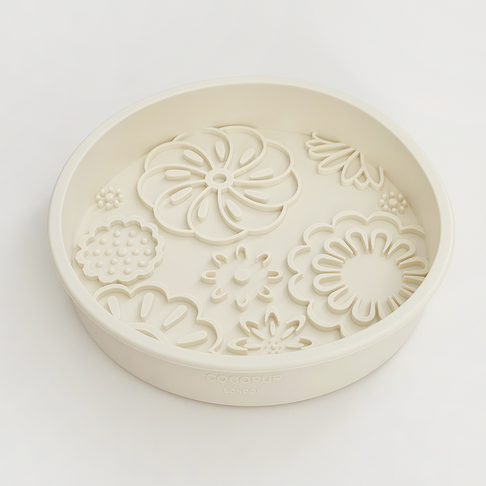 Cream dog bowl with raised floral designs inside, Cocopup London Slow Feeder Lick style.