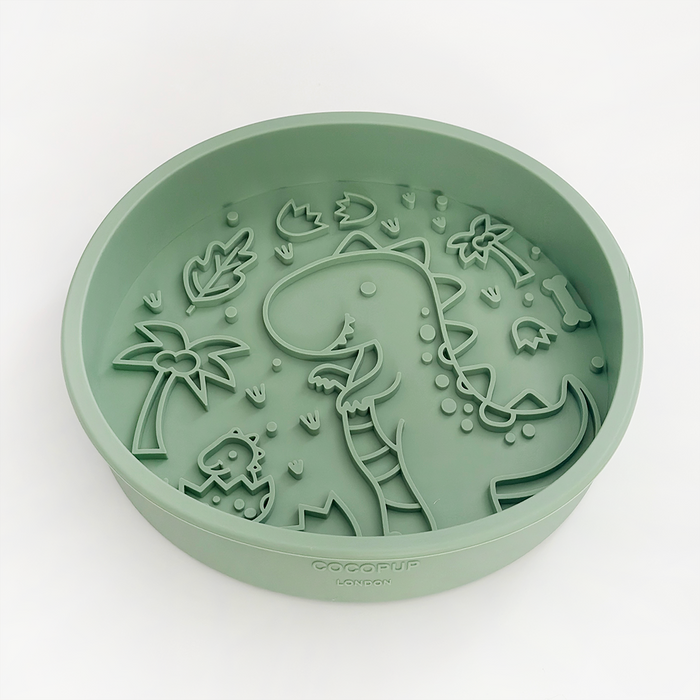 Sage green silicone dog slow feeder bowl with raised dinosaur pattern by Cocopup London.