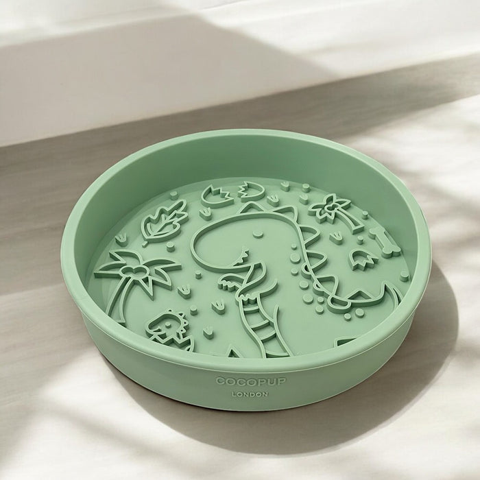 Green slow feeder dog bowl with raised dinosaur and plant pattern from Cocopup London’s Dinopaws collection.