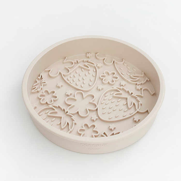 Beige slow feeder dog bowl with raised strawberry and flower shapes, Cocopup London Pupberry Fields design.