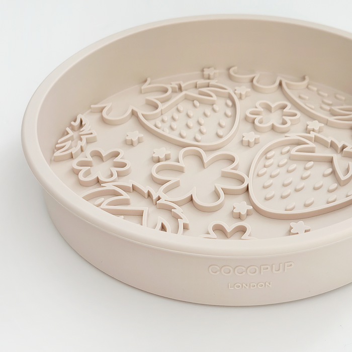 Round beige silicone dog bowl with raised strawberry and flower shapes, Pupberry Fields design by Cocopup London.