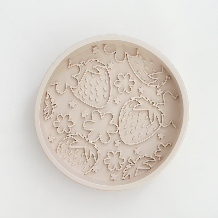 Beige slow feeder dog bowl with strawberry, flower, and star-shaped cutouts.