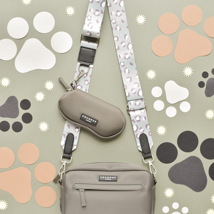 Mocha brown Cocopup London sunglasses case on a white background with black paw prints.