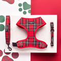 Tartan-patterned Cocopup London harness, lead, and collar set displayed on marble with red and white paw print background.