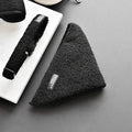 Black textured dog accessories on a dark surface, including a triangular Teddy Bandana - Baloo from the Cocopup London range, a collar, and a harness. The items feature tags with branding, positioned on a white marble slab.