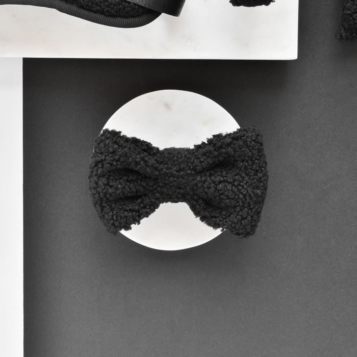 Teddy bow tie in Baloo print by Cocopup London, displayed on a white circle with black and white geometric accents.