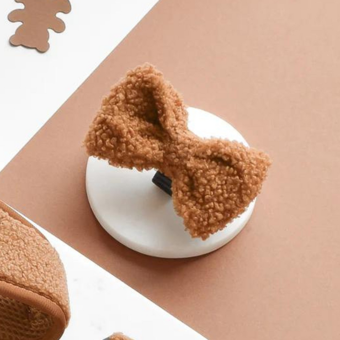 Textured brown bow tie with a soft, teddy-like finish, shown alongside matching brown dog accessories.