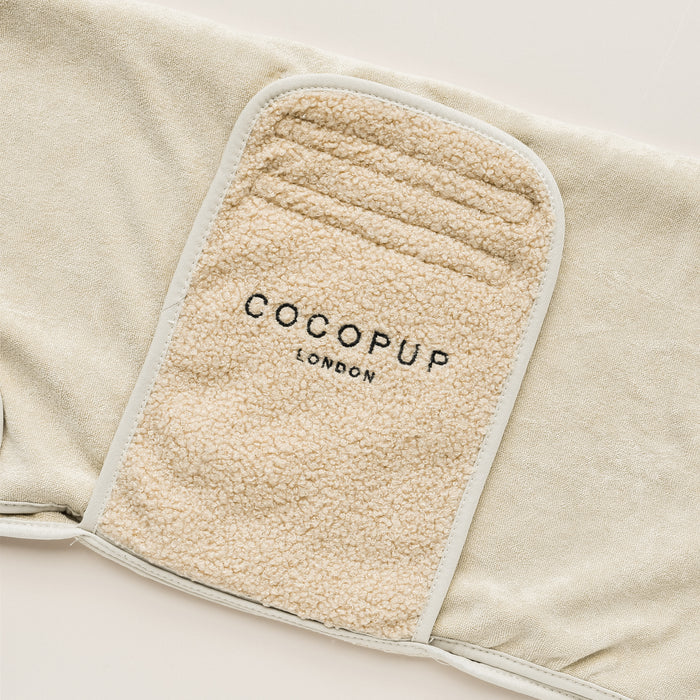 A soft-textured, light brown dog harness with "Cocopup London" embroidered in black on the front, designed for comfort with beveled edges and light beige piping. Pair it with the Teddy Drying Robe for a complete, cozy look.