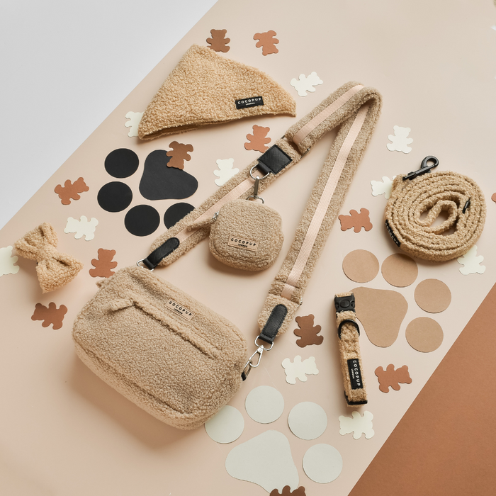 Beige dog walking bag bundle with matching accessories on a beige background.