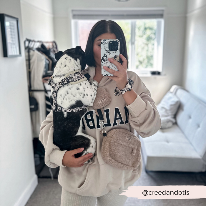 Woman in beige outfit holds black and white dog, both with beige Cocopup London Teddy Rupert fleece bag.