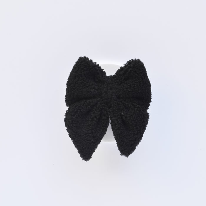 Fluffy black textured pet bow tie with a sailor-style shape, displayed on a plain white background.