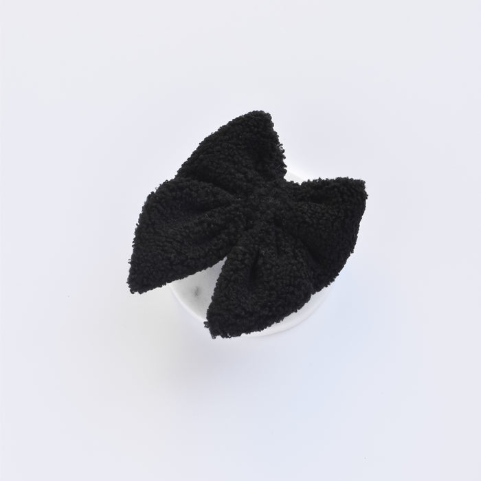 Black textured sailor bow tie with white base by Cocopup London, displayed on a light grey background.