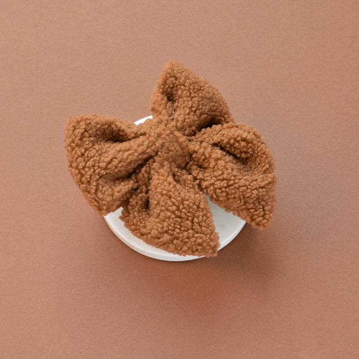 Cocopup London Teddy Sailor Bow Tie in Paddington pattern on a white dish, brown background.