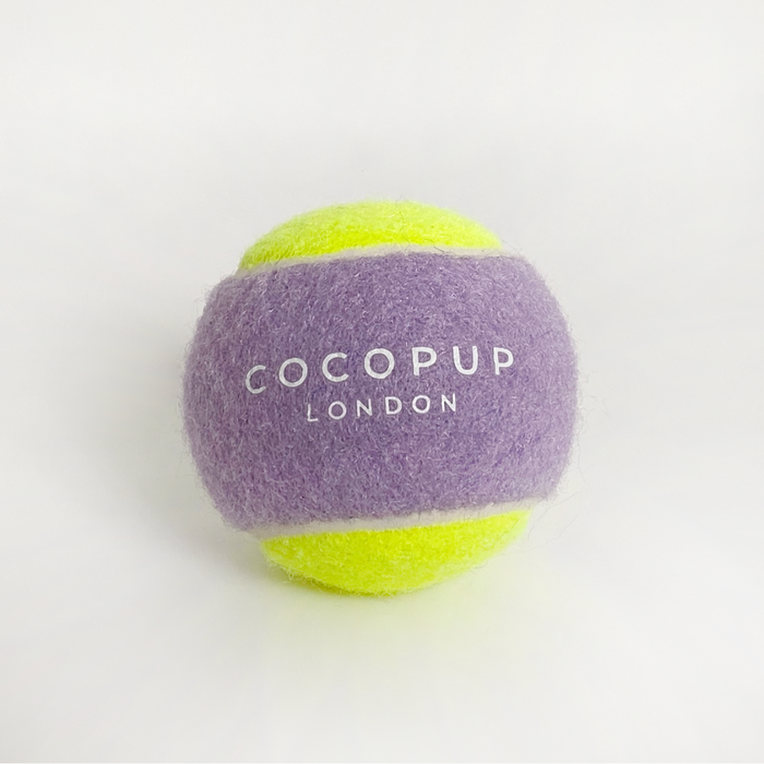 Lilac and yellow Cocopup London tennis ball dog toy on a white background.