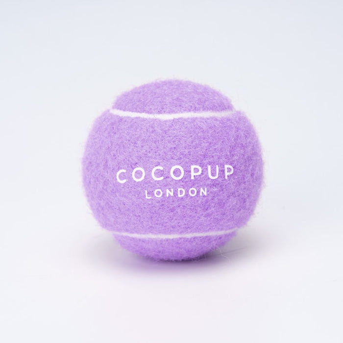 Lilac Cocopup London tennis ball fetch toy with white branding on a plain background.