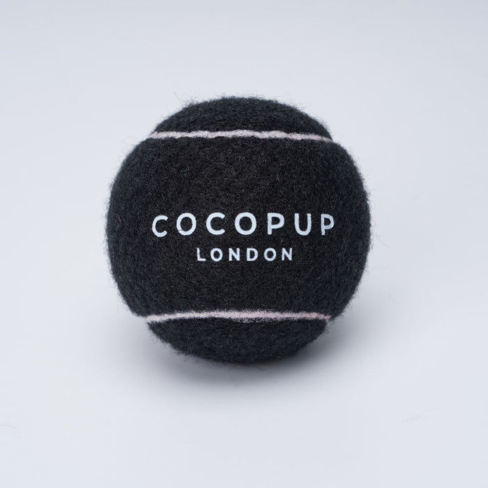 Midnight black tennis ball with white stripes, designed for dogs; Cocopup London logo visible.