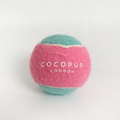 Pink and blue Cocopup London tennis ball dog toy with a durable texture.