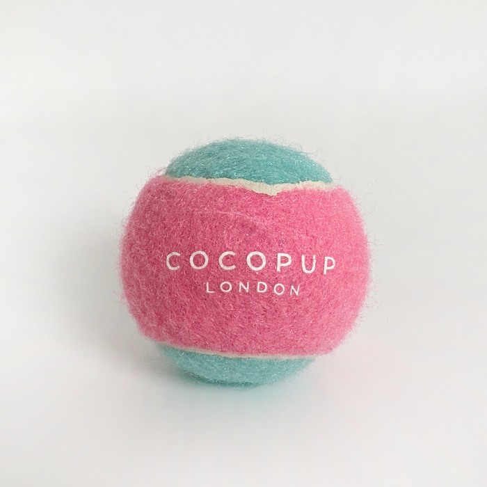 Pink and blue Cocopup London tennis ball dog toy with a durable texture.