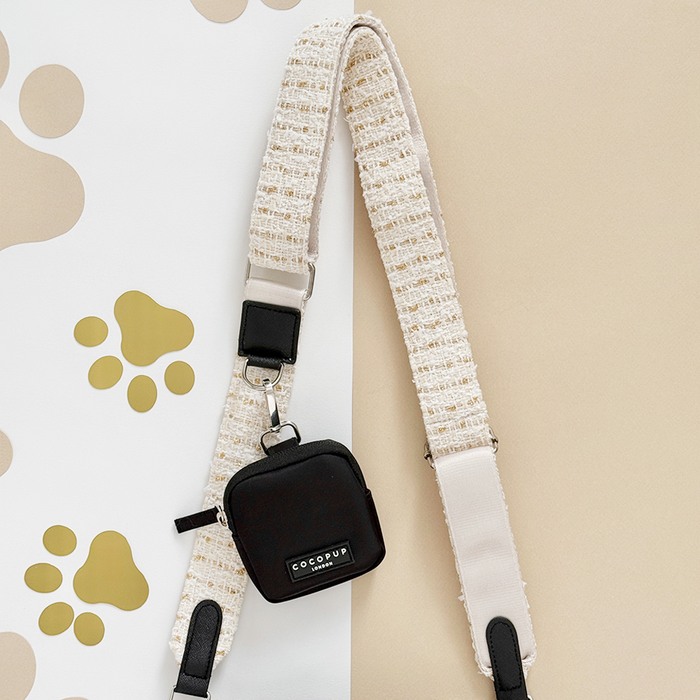 Vanilla textured tweed bag strap with small black pouch, Cocopup London branding visible on accessory.