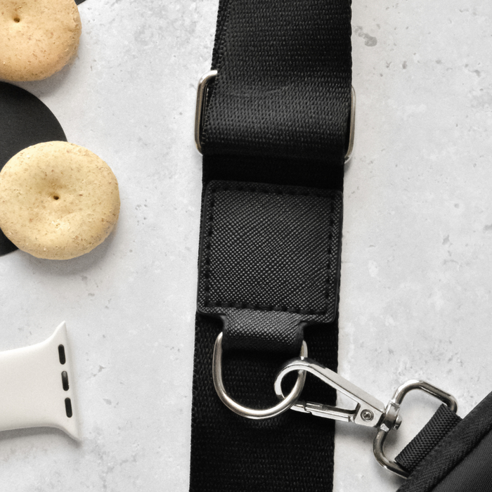 Black Cocopup London dog walking bag bundle on a light gray surface.