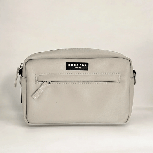 Caramel brown Cocopup London dog walking bag with front zip pocket and black logo label.