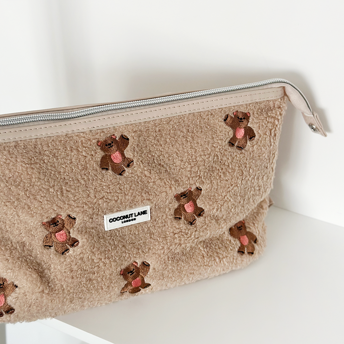 Cream expandable makeup bag with embroidered teddy bear design and zip closure by Cocopup London.