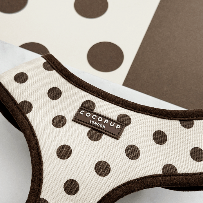 Dog harness with brown polka dots and 'Cocopup London' label on a neutral background