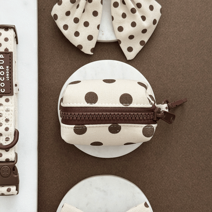 Polka dot pouch with brown zipper on a brown background