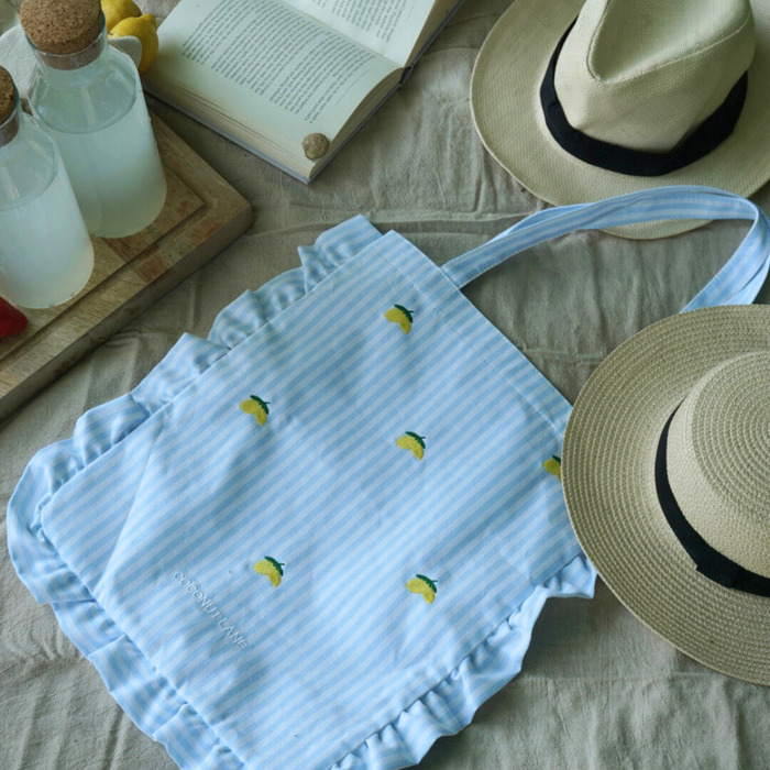 Beige tote bag with embroidered yellow lemons, Cocopup London by Coconut Lane.