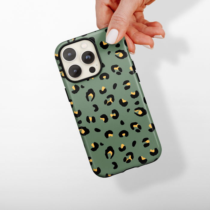 Khaki leopard print Cocopup London Tough Phone Case held in a hand against a white background.