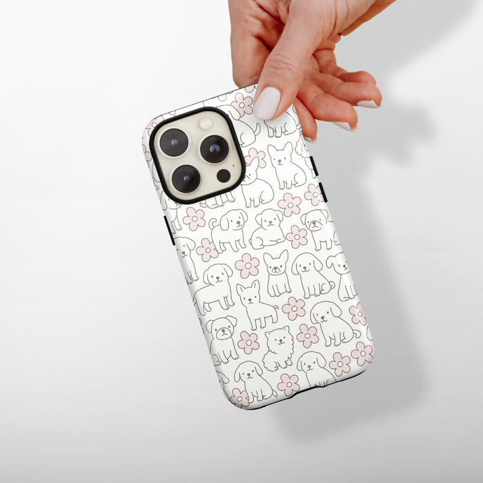 Hand holding Cocopup London Tough Phone Case with a white background and outlined dog and floral patterns.