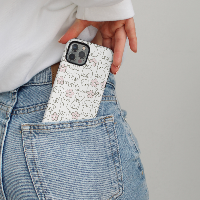 Pawfect Blooms floral phone case by Cocopup London partially visible in the back pocket of blue jeans.