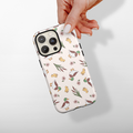 Hand holding a Cocopup London phone case with a white background and playful pups, plants, and flowers pattern.