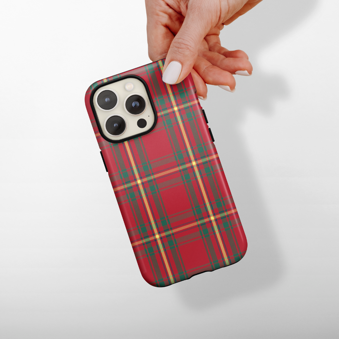 Hand holding a Cocopup London phone case with a red tartan plaid pattern.