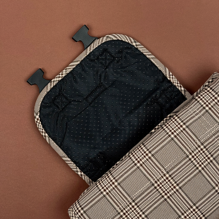 Plaid Cocopup London travel mat open next to matching bag, both on a brown surface.