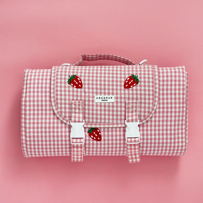 Pink gingham picnic bag with a small strawberry embroidered detail.