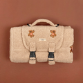 Beige fuzzy bag with teddy bear patches and black buckles.