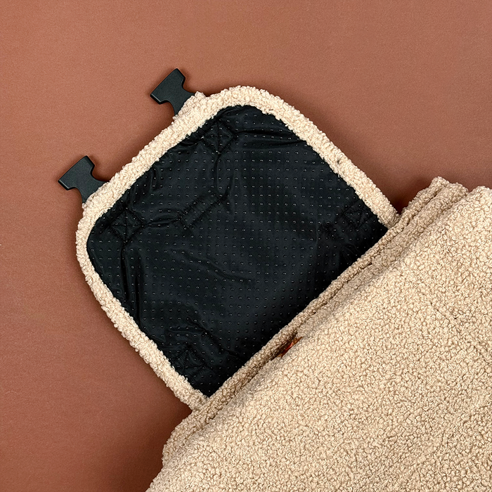 Beige Cocopup London travel mat with Theo embroidery, black fleece underside, and buckle clips.