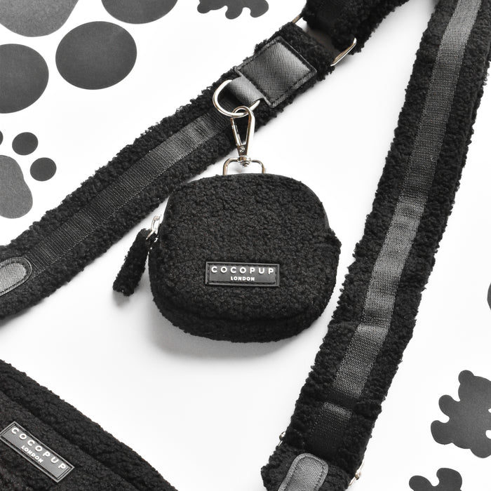 Teddy Baloo treat pouch by Cocopup London, black textured finish with paw prints, matching straps, on white background.