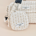 Vanilla tweed treat pouch with gold accents by Cocopup London, shown on a beige background.