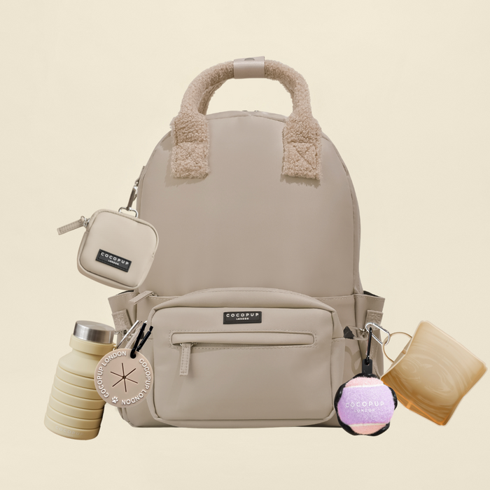 Caramel-colored rucksack with fleece handles, matching keychains, bottle, and mug from Cocopup London.