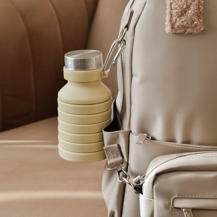 Caramel Latte rucksack bundle by Cocopup London in tan fabric with matching accessories, shown neatly arranged.