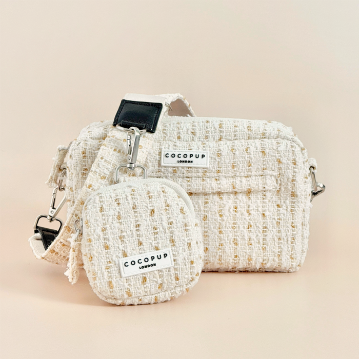 Vanilla tweed dog walking bag set with matching coin purse and poop bag dispenser, all in textured fabric.