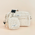 Vanilla tweed dog walking bag set with matching coin purse and poop bag dispenser, all in textured fabric.