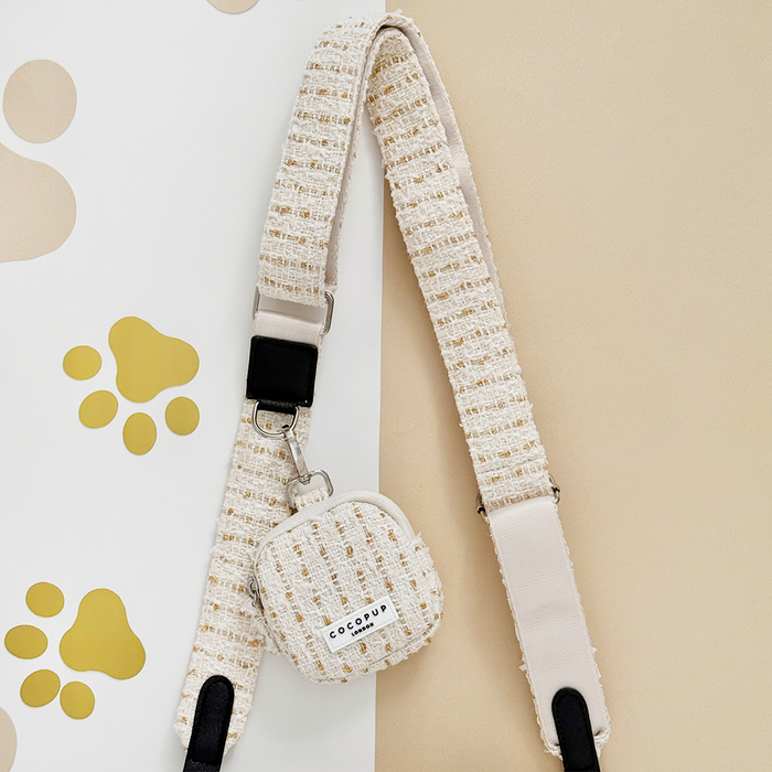 Cocopup London vanilla textured tweed dog walking bag bundle on a beige and white background.
