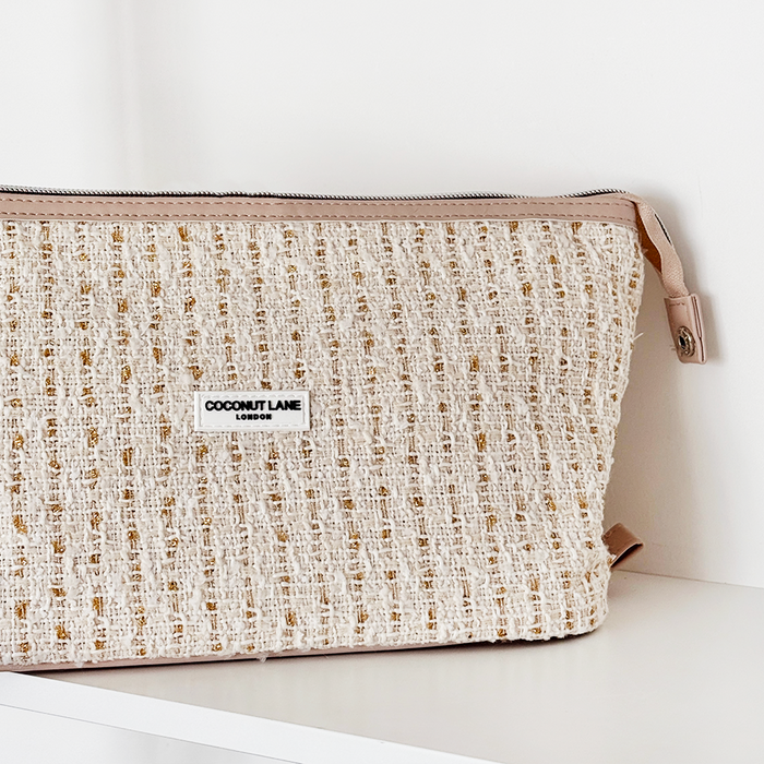 Vanilla textured tweed makeup bag with gold flecks and tan leather trim.