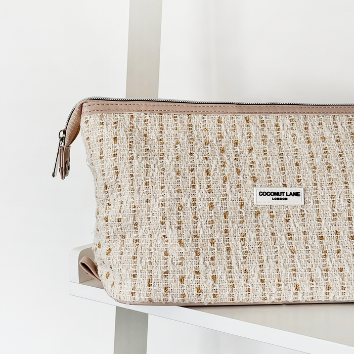 Vanilla tweed expandable makeup bag with textured finish by Cocopup London on a white shelf.