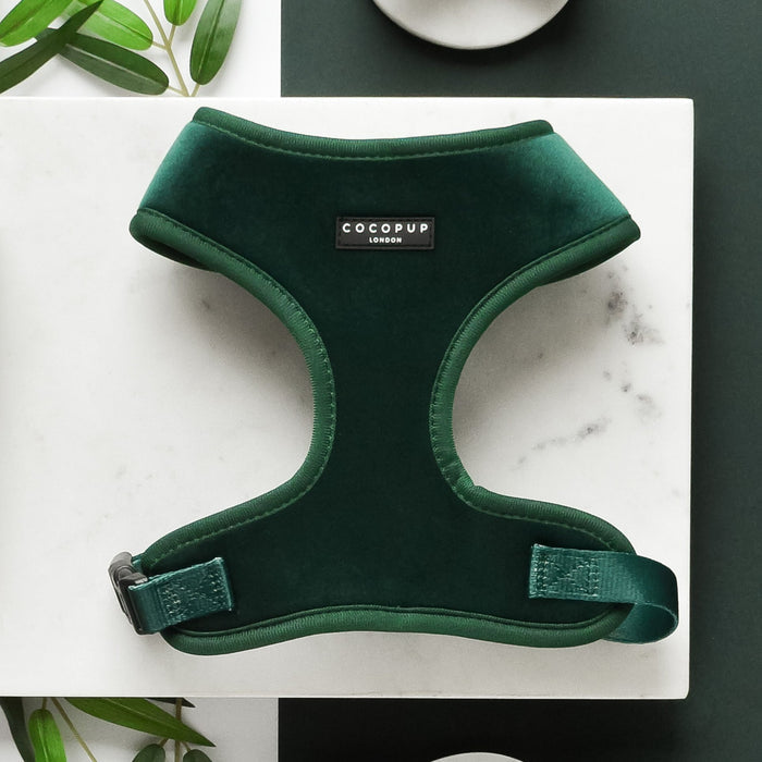 Forest green velvet dog harness, lead, and collar set from Cocopup London on a white marble surface.
